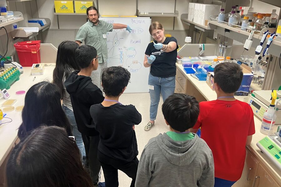 Scholars from UW Robinson Center for Young Scholars listen to a presentation on DNA from BBI Research Lab Manager Nahum Smith (left) and Research Scientist Sabrina Best